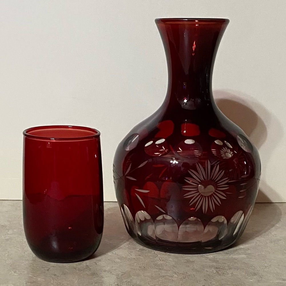 Vintage cranberry cut to clear glass decanter with small glass. Two pieces